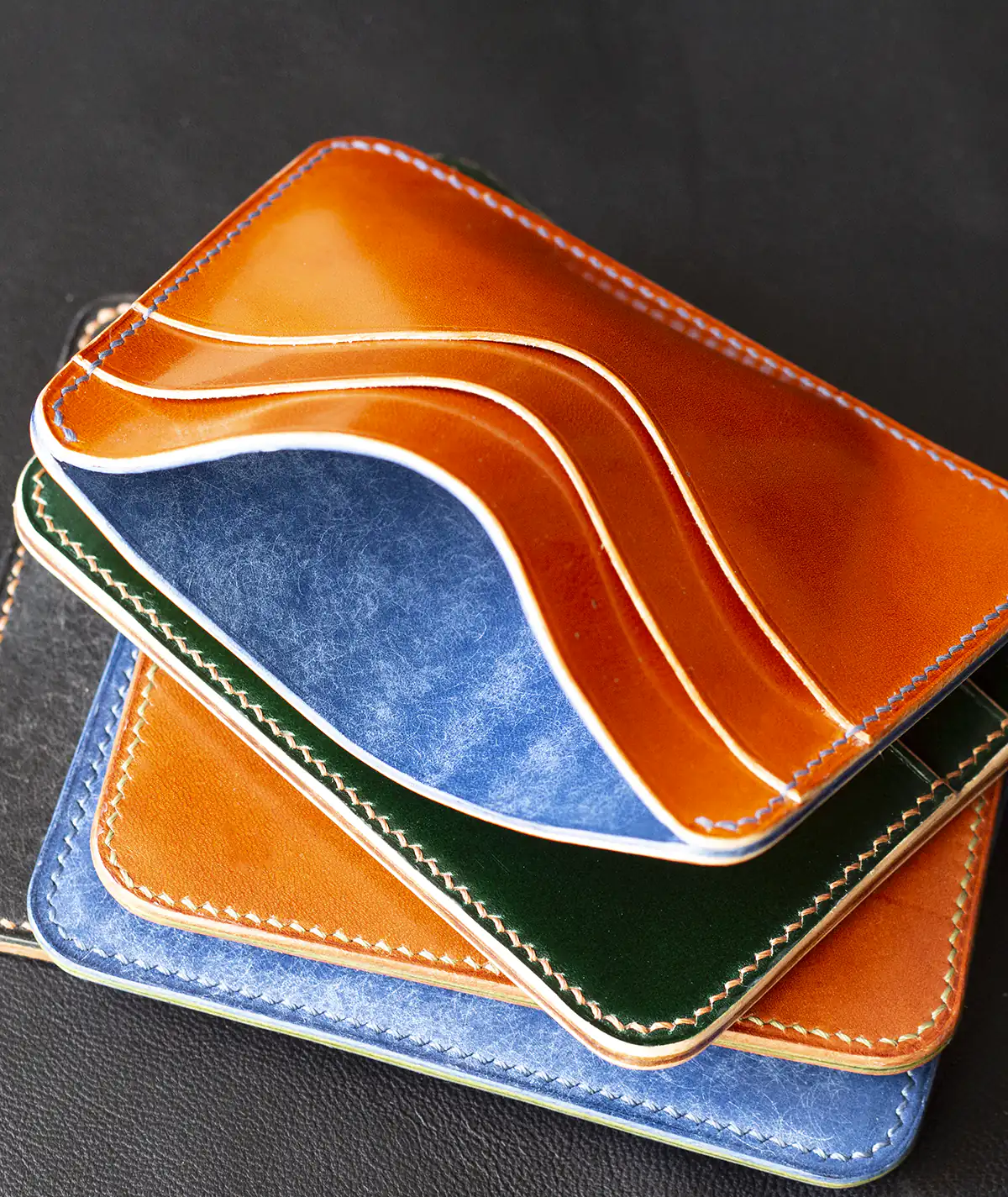 stack of handmade leather card wallets